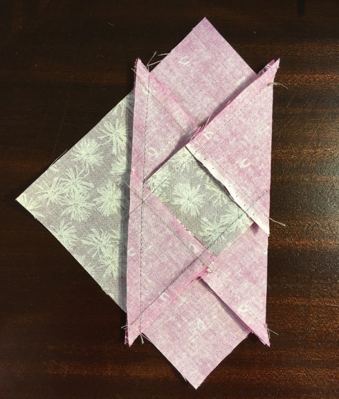 Lay the center section on the large triangle, aligning the triangle tips
